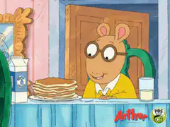 Arthur eats a stack of pancakes