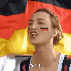 Woman with German flag face paint laughing