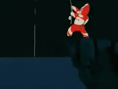 Candy Cane Man climbing cliff