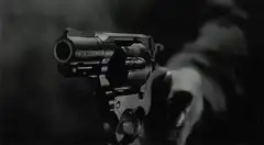 revolver firing in black and white