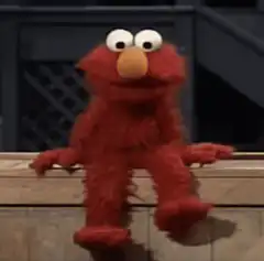 Elmo sitting on a ledge