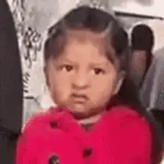 Little girl in red hoodie looking skeptical