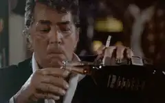 Dean Martin drinking from a bottle