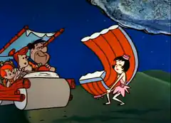 Wilma and Fred Flintstone in a stone car