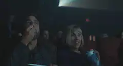 Couple laughing hysterically in movie theater