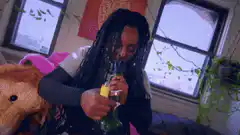 Woman drinking from a bottle and looking up