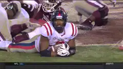 Football player smiles and waves