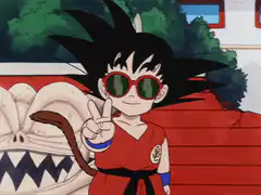 Goku wearing sunglasses and making a peace sign
