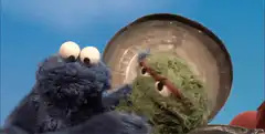 Cookie Monster eats Oscar the Grouch