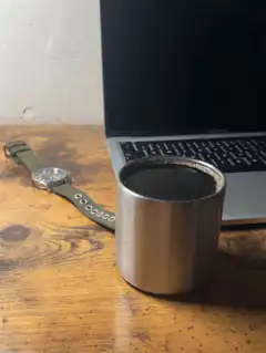 coffee cup on desk with laptop