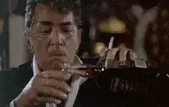 Dean Martin drinks from a bottle