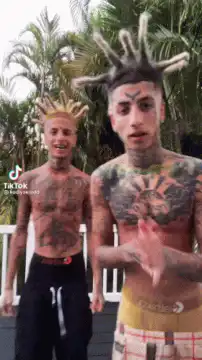 Two tattooed men dancing outdoors