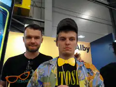 Two men at a convention with props