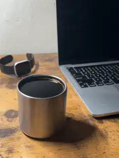 coffee cup and laptop on desk