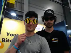 Two men at a Bitcoin event with bee sunglasses
