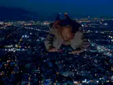 Man flying over city at night