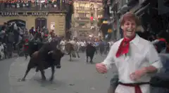 Man dancing in front of running bulls