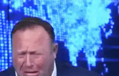 Man crying in front of blue screen
