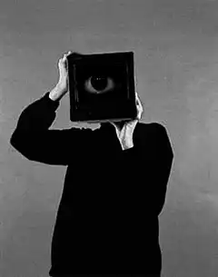 Person holding TV with eye