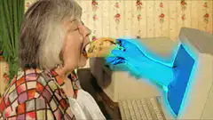 Old lady eating cookie from computer screen