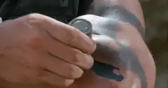 Arnold Schwarzenegger applying face paint
