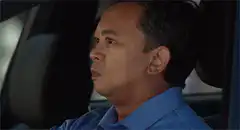 Man in car gives a thumbs up