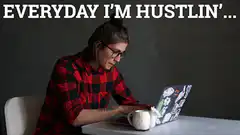 Woman drinking from sheep mug while typing