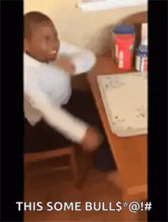 Boy at desk looking shocked