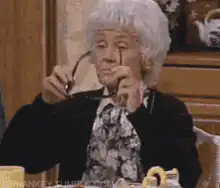 Lucille Ball puts on sunglasses