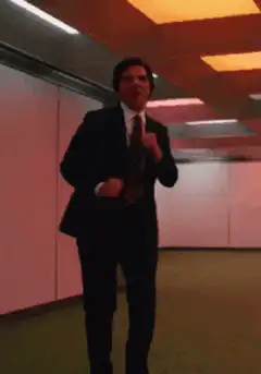 Man in suit dancing excitedly