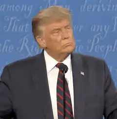 Donald Trump smirking and waving