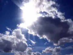 Sun shining through moving clouds