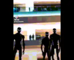 Silhouette figures walking in a mall