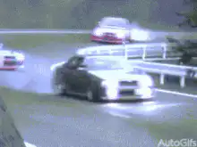 Multiple cars drifting on a winding road