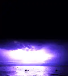 purple lightning storm over ocean