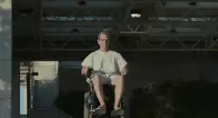 Man in hospital gown in wheelchair