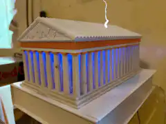 Greek temple model with blue lights and lightning