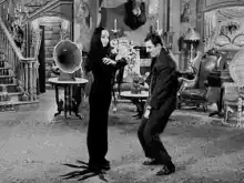 Gomez and Morticia Addams dancing