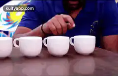 Man playing shell game with cups