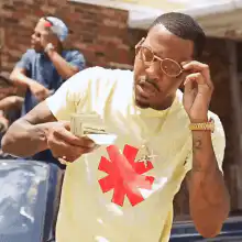 Tyler the Creator wipes money on his face