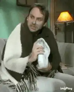 Man with cold sniffing tissue