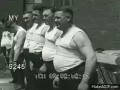 Men in white tank tops standing in line