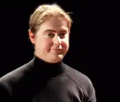 Man in turtleneck nodding and smiling