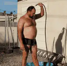 Man rinsing off with a hose