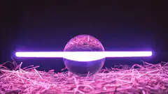 Glowing light tubes behind glass sphere