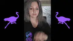 Woman making hand gestures with purple ostriches