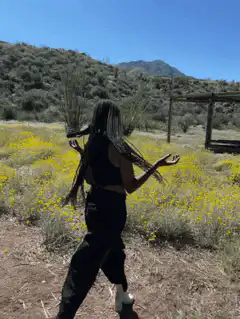 woman dancing in yellow flowers