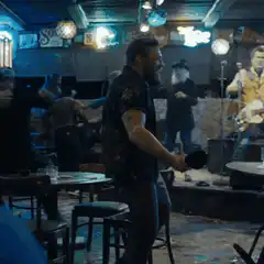 Jax Teller playing drums in a bar