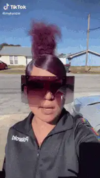 Woman removes face shield to reveal makeup