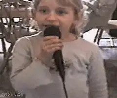 Little girl singing into microphone